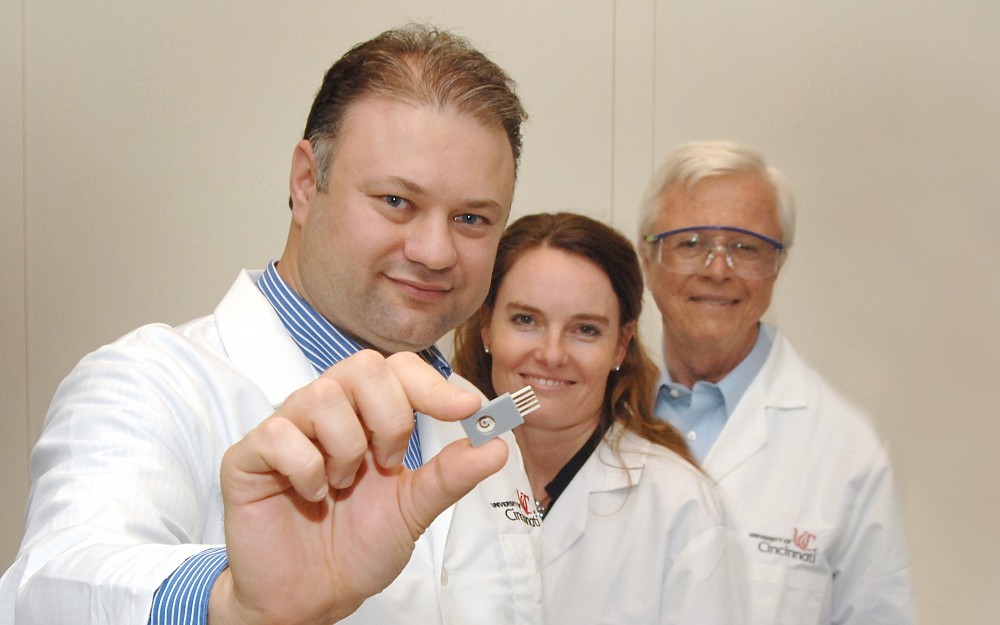 Ian Papautsky, PhD, displays portable sensor. With him are research team members Erin Haynes, DrPH, and William Heineman, PhD.