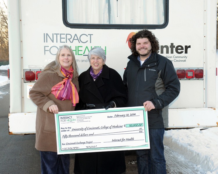 Ann Barnum, Judith Feinberg, MD, and Adam Reilly, pose in front of the RV used by the Cincinnati Exchange Project.