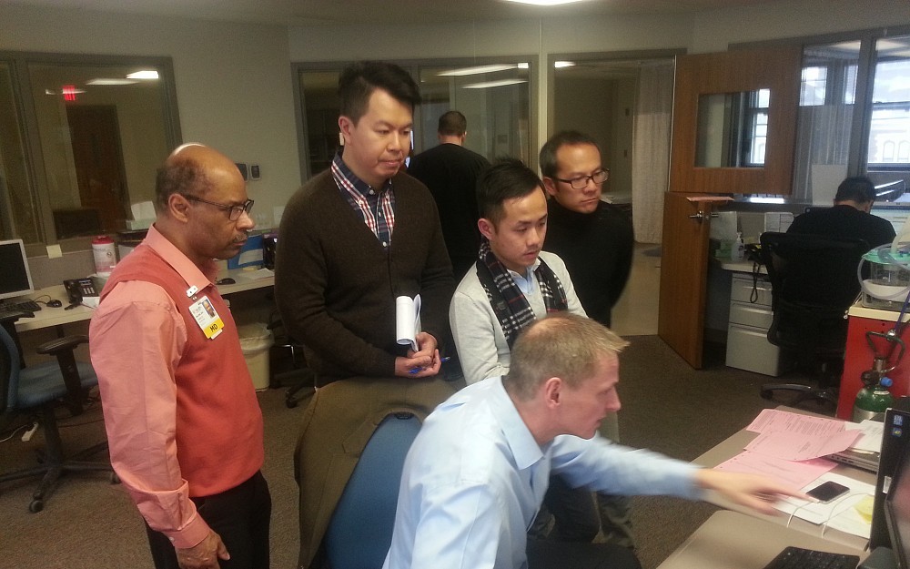Bryan Griffin, DO, gave visitors from Hong Kong a tour of UC Medical Center Psychiatric Services at Deaconess Friday, Feb. 14. At left is Charles Collins, MD.