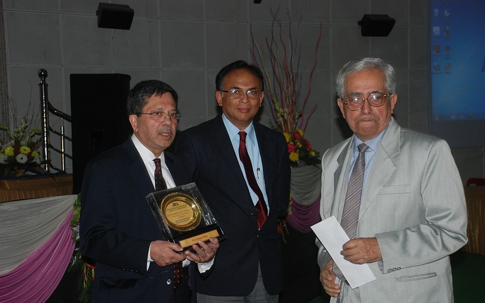 Ranjan Deka, PhD (left), receives a memorial plaque from Dr. A.K. Danda (right), member-secretary Indian National Confederation and Academy of Anthropologists, and Prof. A.K. Buragohain (center), vice chancellor, Dibrugarh University.