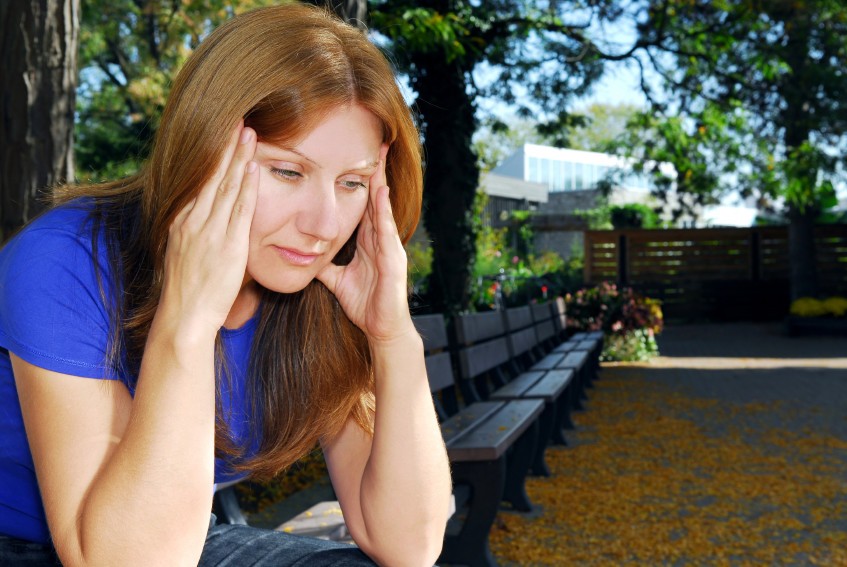 A woman suffering from a migraine.
