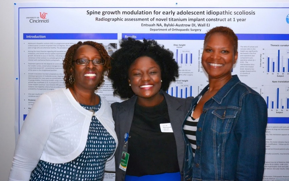 Nana Entsuah, a senior at UC and part of the McNair Scholars Program, center, displays her summer research in CARE/Crawley Atrium.