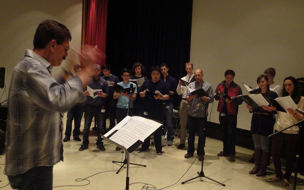 Bruce Giffin, PhD, directs the choir as they practice for the 2013 IvaDean benefit concert.