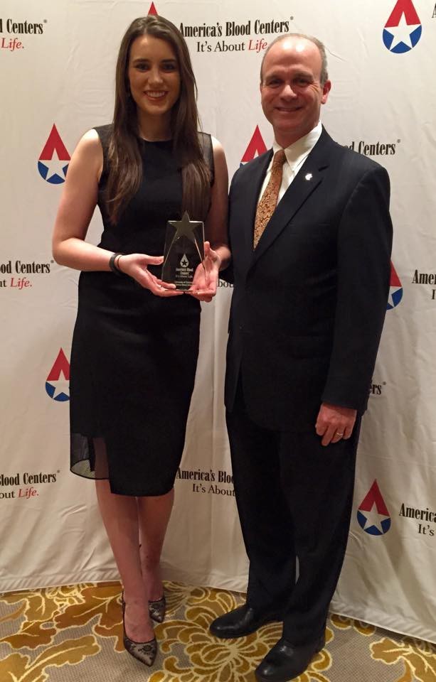 Christiana Beer, 2014-15 UC student body president, and Greg Vehr, UCÂ s vice president for governmental relations and university communications, with the School Blood Drive Award. 