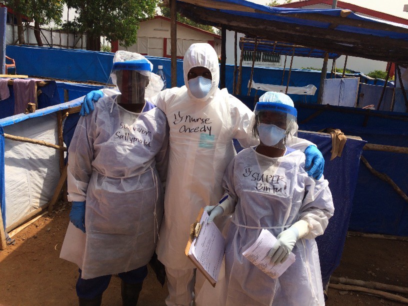 Cheedy JaJa, PhD, (center) and colleagues at the Marfoki Ebola Treatment Unit in Sierra Leone.