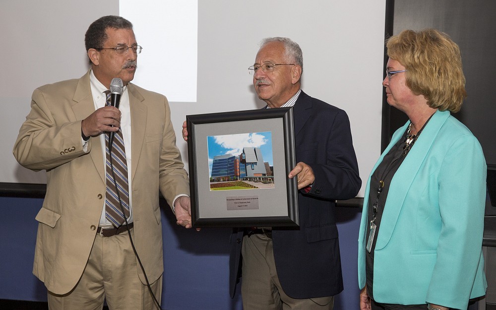 Peter Stambrook, PhD (center), receives his Lifetime of Achievement in Research Award from William Ball, MD, dean of the College of Medicine, and Melanie Cushion, PhD, senior associate dean for research.