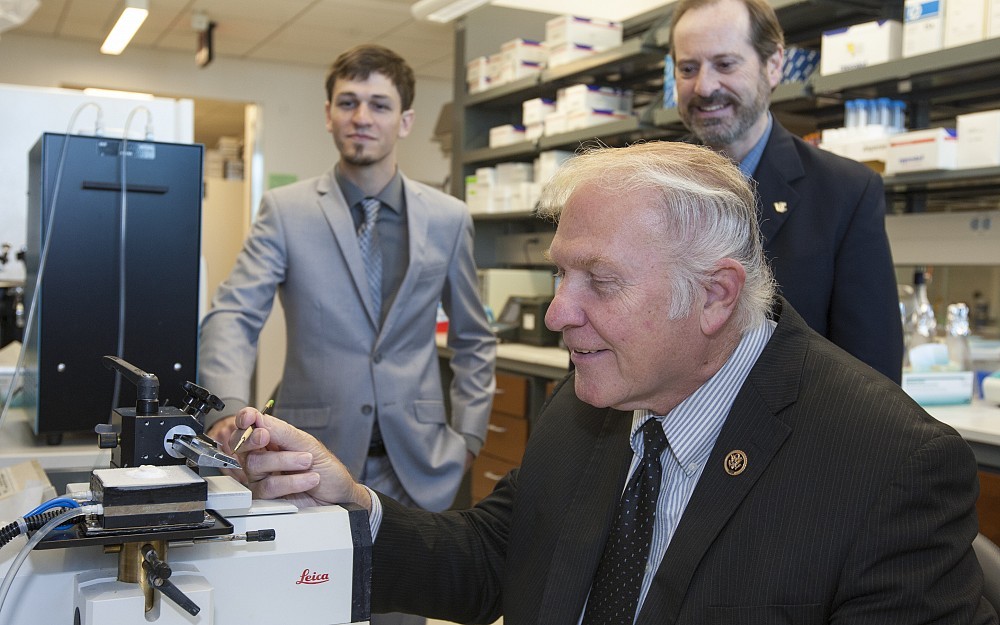 U.S. Rep. Steve Chabot toured a neuroscience laboratory with doctoral student Ryan Makinson (left) and Professor Kim Seroogy, PhD (right).