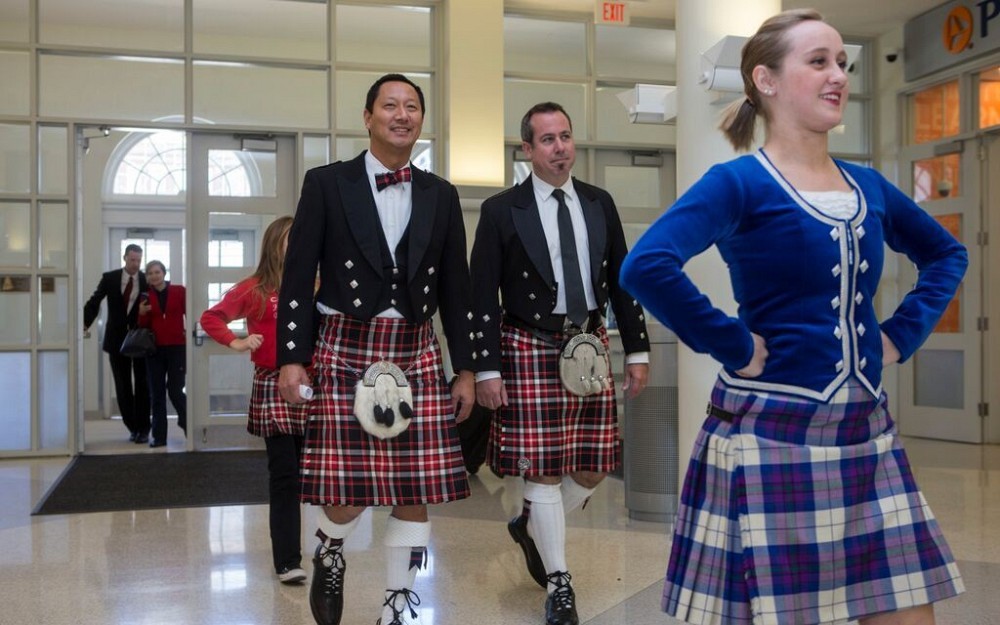 President Santa Ono, PhD, and James L. Winkle College of Pharmacy Dean Neil MacKinnon, PhD, sport the new UC tartan with the Cincinnati Scots Highland Dancers just ahead of them.