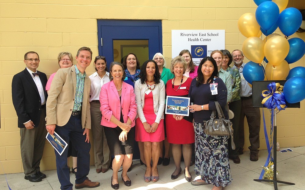 Representatives from the University of Cincinnati College of Medicine and College of Nursing, Cincinnati Health Department, Riverview East and Children's Hospital celebrate the grand opening of the Riverview East School Health Center in September, 2014.