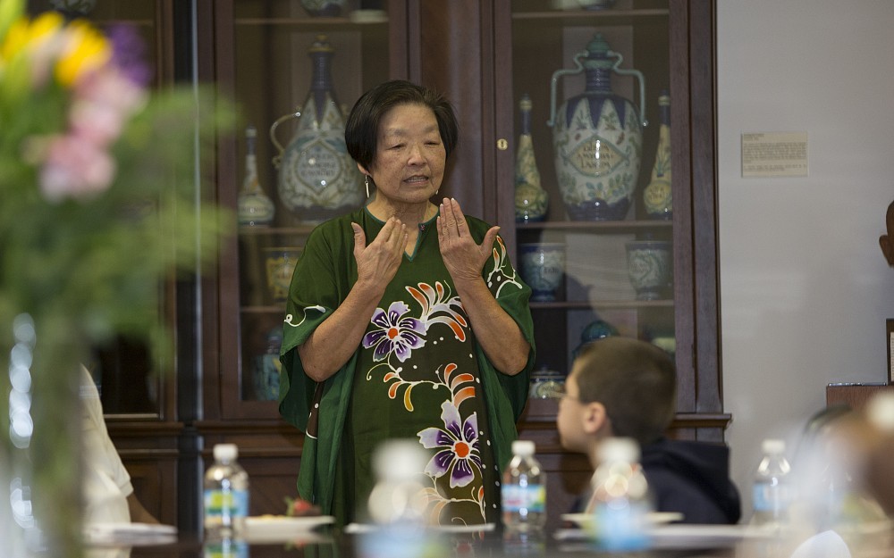 Wan Lim, PhD, associate professor emerita, is shown speaking with students during a special UC Med Mentors cemerony in COM's Lucas Board Room.
