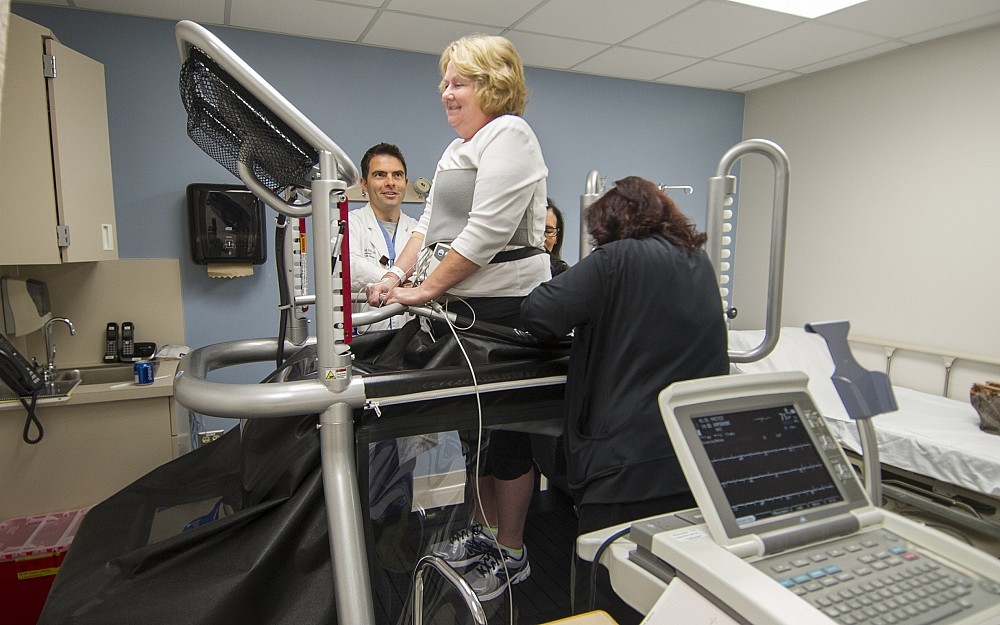 Patrick Daly, MD, watches as Marilyn Cotter used an anti-gravity treadmill at UC Medical Center.