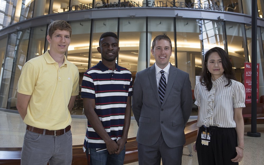 Mark Althoff, Kobina Essandoh, David Milewski and Hisako Fujiwara are shown in the CARE/Crawley Atrium.
