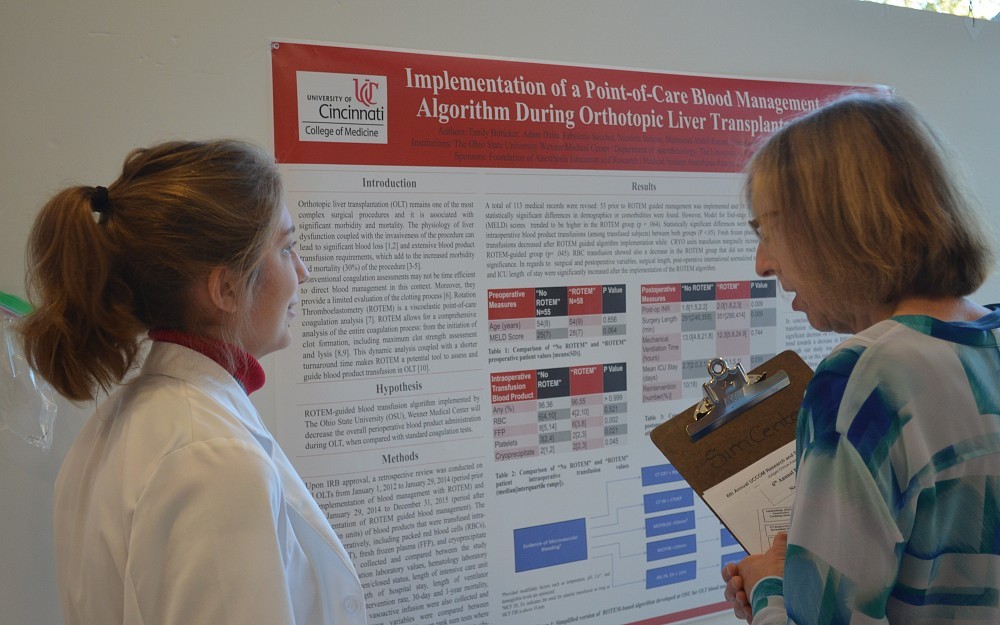 Emily Bitticker, a second-year medical student, discusses her research at the sixth annual Research and Service Symposium held Nov. 18, 2016, in CARE Crawley Atrium.
