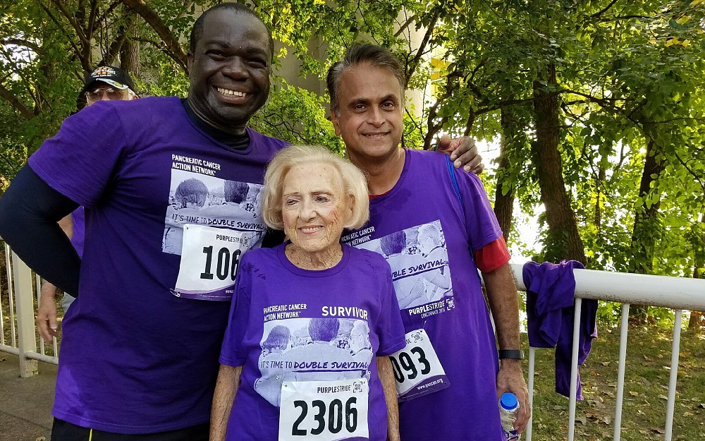 Marion Croswell, 97, a pancreatic cancer patient at the Purple Stride Walk in September with her oncologist Olugbenga Olowokure, MD, (aka Dr. Benga), associate professor in the Division of Hematology Oncology at the UC College of Medicine, UC Health oncologist and a member of the UC Cancer Institute. and Syed Ahmad, MD, a College of Medicine faculty member and a UC Health and UC Cancer Institute surgical oncologist. 