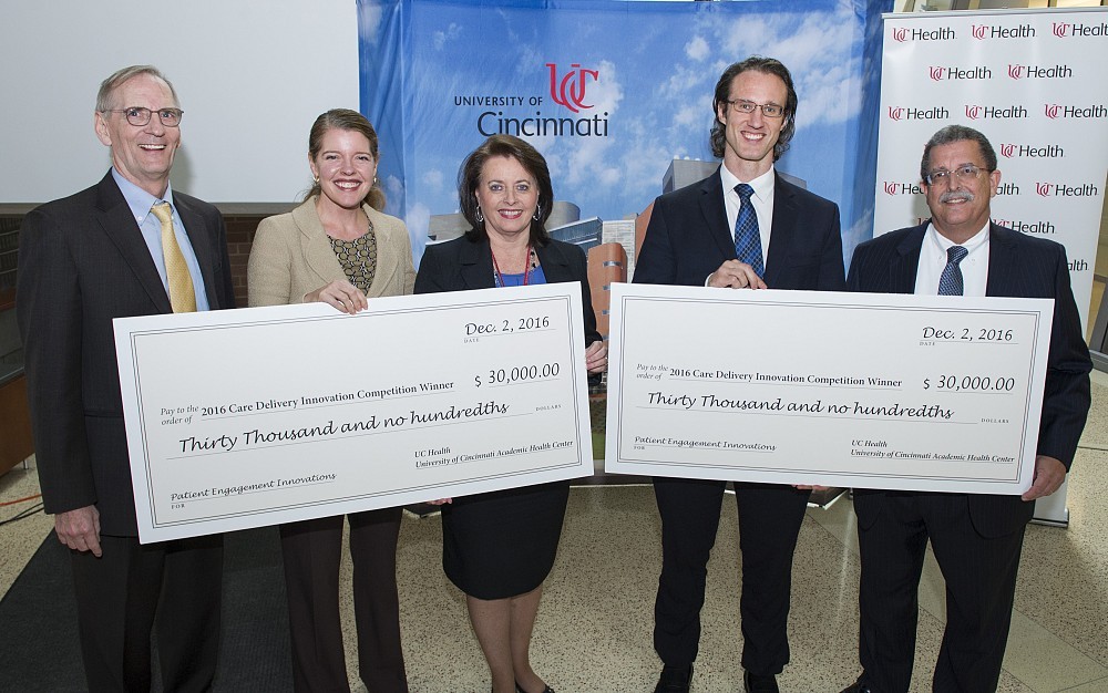 UC Health President Richard Lofgren, MD, Tiffiny Diers, MD, Jill Boone, PharmD, Dylan Steen, MD, and Dean William Ball of the College of Medicine are shown in CARE Crawley Atrium.