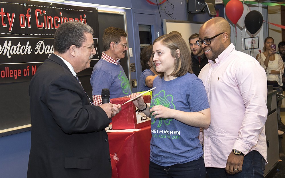 College of Medicine Dean William Ball, MD, gives Margaret Jones her match as her husband Jason looks on