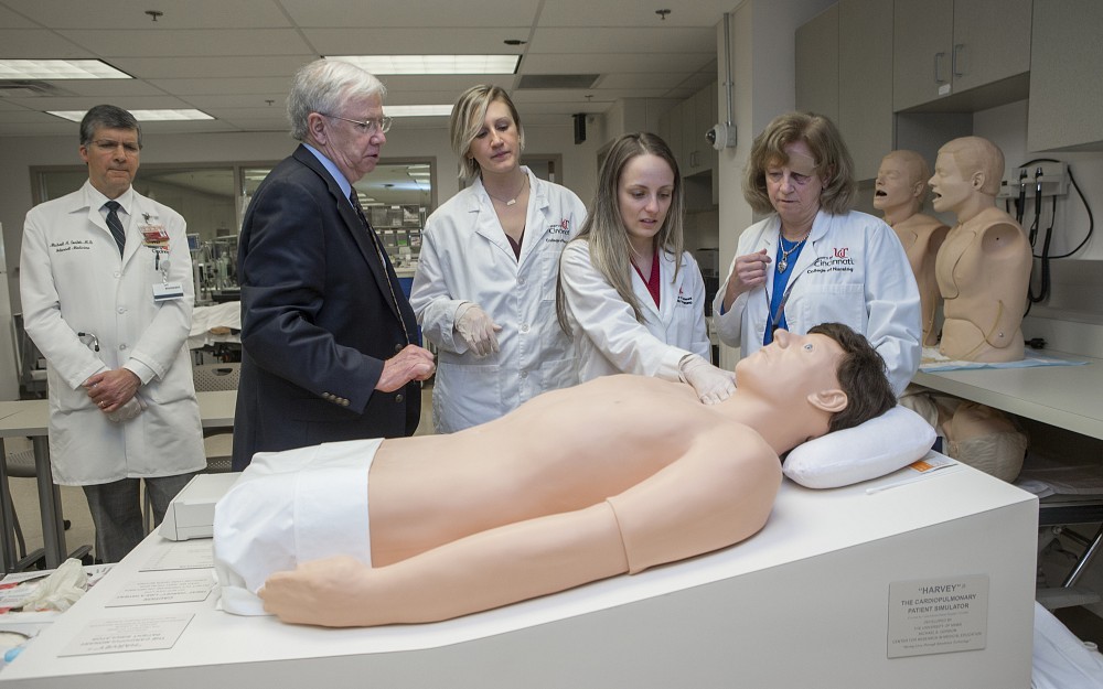 Michael Sostok, MD, (left), Harry Fry, MD, nursing students Emily Weber and Jessie Boxwell, and Kathe Ballman, DNP, MSN, associate professor in the College of Nursing with medical simulator Harvey