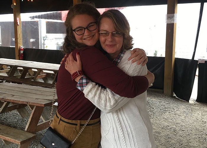 "Blood sisters" Olivia Lawrence and Melinda Anderson hug during their first time meeting Dec. 23, 2017 at Eli's Barbecue in Cincinnati. Lawrence provided bone marrow for Anderson's bone marrow transplant in April 2016. Since first connecting, they call each other "blood sisters."