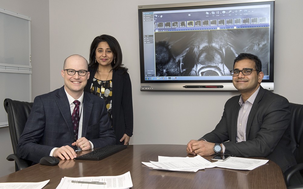 Abhinav Sidana, MD, assistant professor of surgery in the Division of Urology (right), Timothy Struve, MD, assistant professor in the Department of Radiation Oncology (left), and Sadhna Verma, MD, adjunct professor in the Department of Radiology (left), all at the University of Cincinnati (UC) College of Medicine, members of the UC Cancer Institute and UC Health physicians,  have created a multidisciplinary prostate cancer clinic for patients to learn about options for treatment and make a decision based on what works best for them.