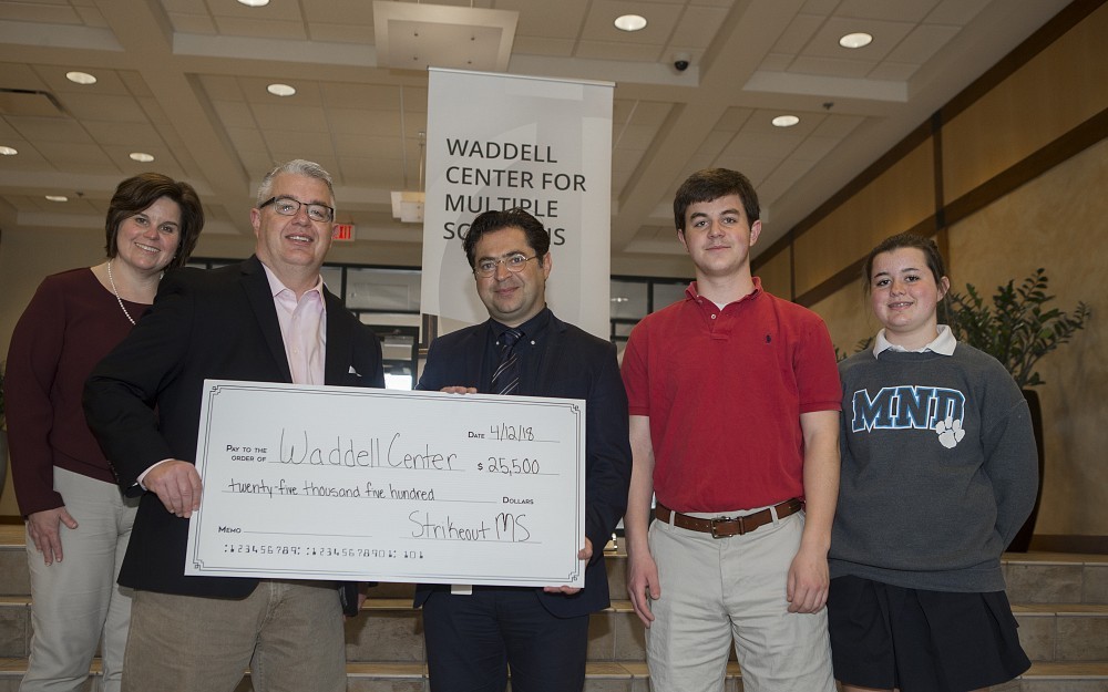 Amy and Hilary Debelak present a donation from Strikeout MS to Aram Zabeti, MD, director of the UC Waddell Center for Multiple Sclerosis. At right are Jack and Maggie Debelak.