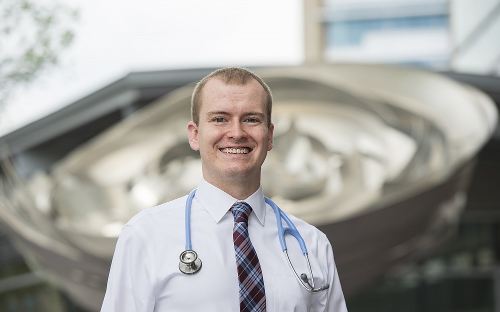 Andrew Frankart, a fourth-year medical student, is shown in front of CARE/Crawley Building.