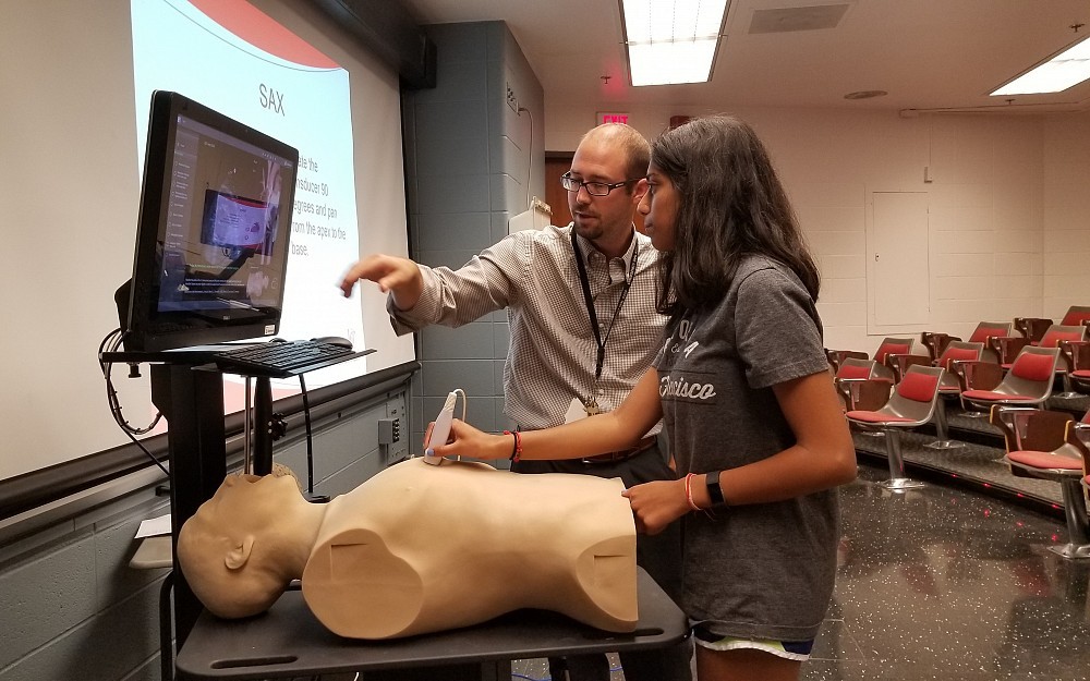 Anidya Soni, a senior at Walnut Hills High School, works with Darek Sanford, MD, a cardiovascular disease fellow, to learn more about the use of ultrasound.  
Photo courtesy of Allie Pendery.