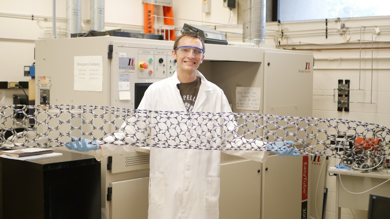 Nichols in lab with large carbon nanotube model