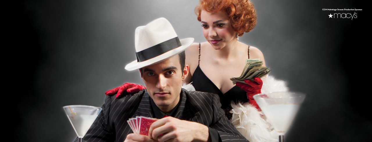 Man playing poker while a woman stands behind him and looks at his cards.