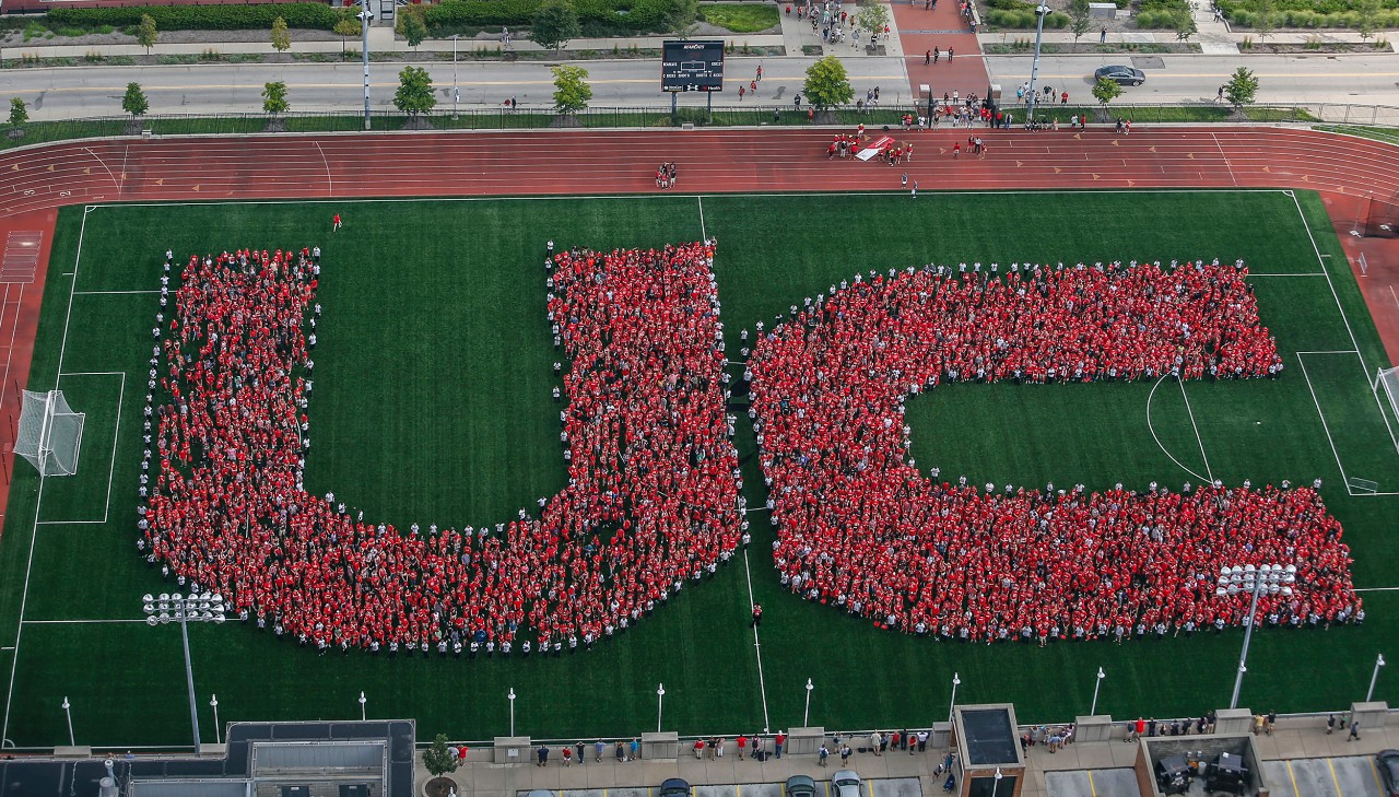 Students spell out UC in Nippert Stadium.