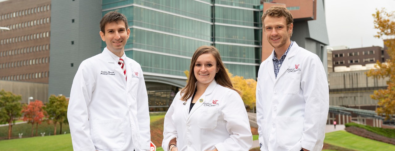 Medical students Andrew Benza, Mckenzie Nelson and Nathan Northern are shown in front of the UC College of Medicine.