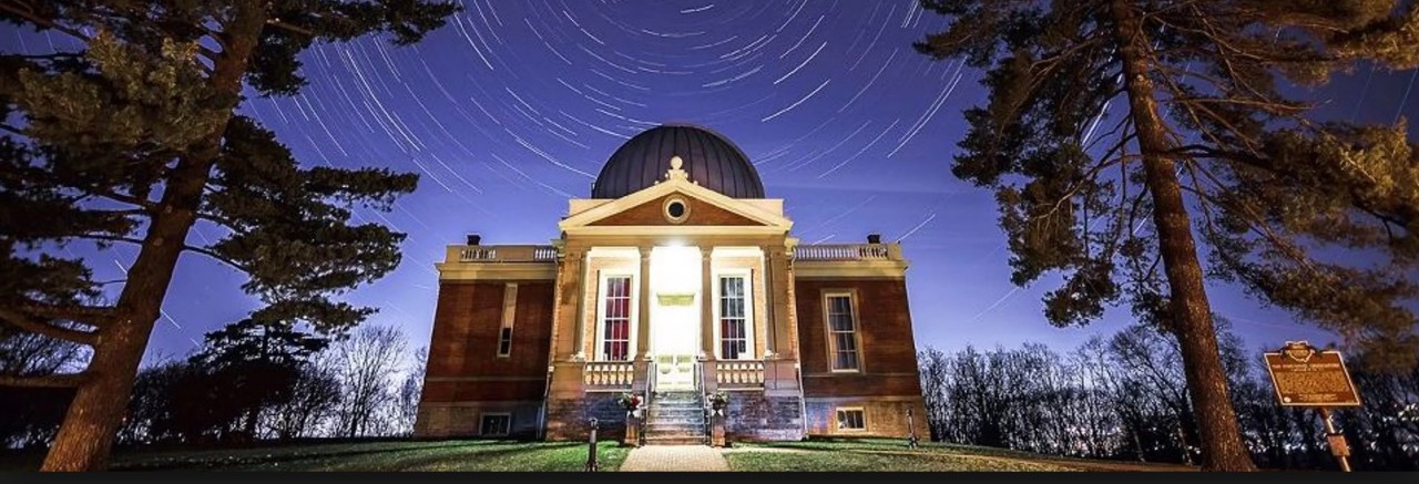 Front of Cincinnati Observatory at night with stars in sky.