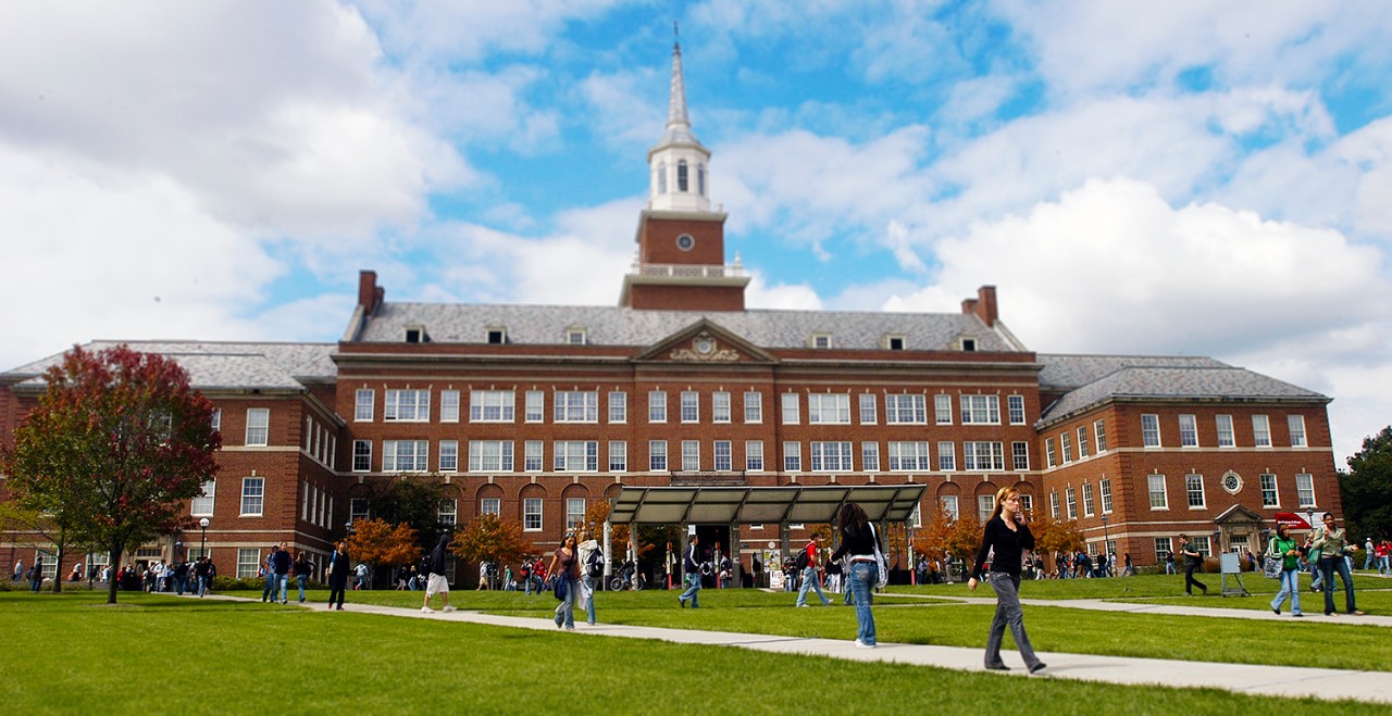 Students walking across McMicken Commons green space to get to class.