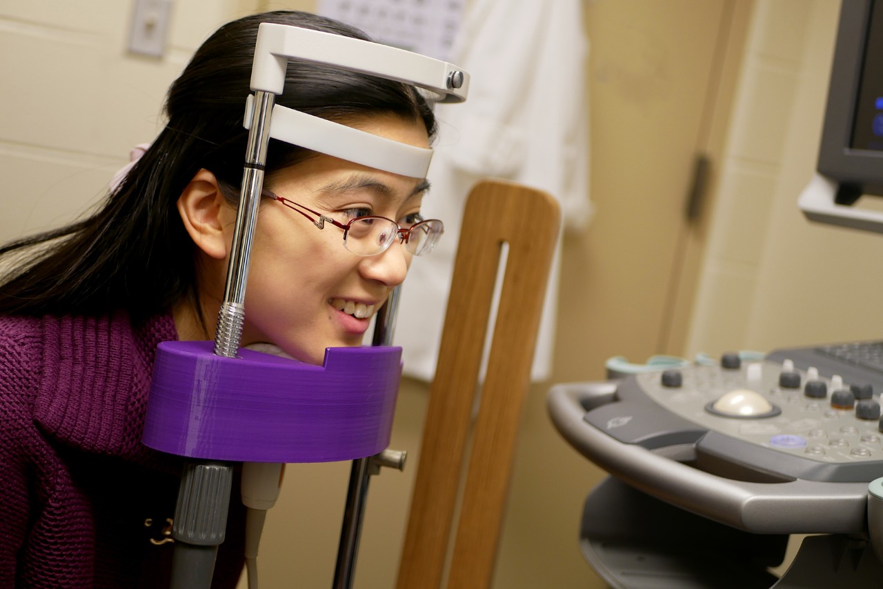 Sarah Li placing head in head stabilization equipment 