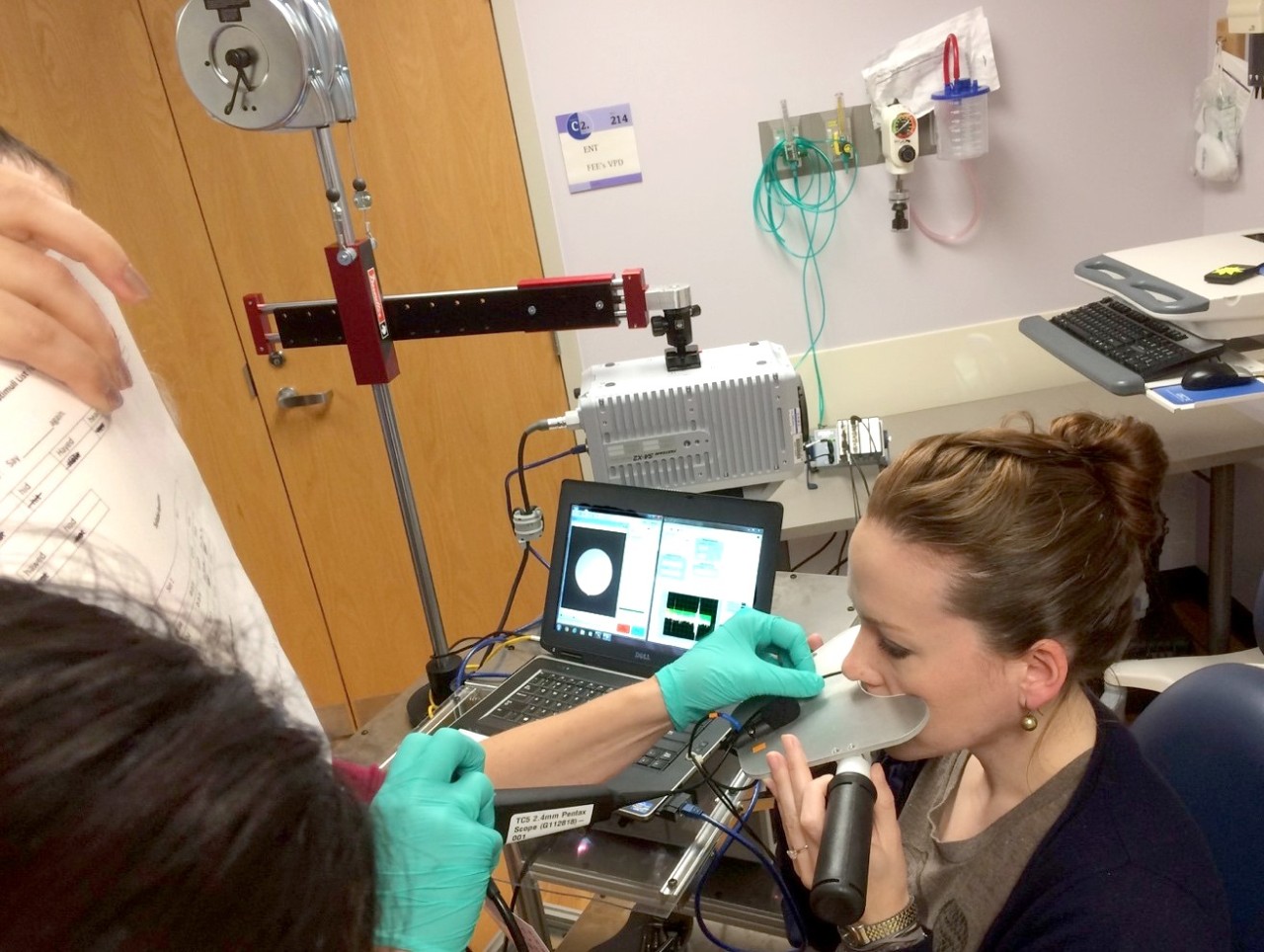 a woman demonstrates the research with an endoscope