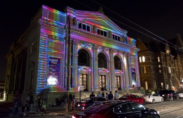multi-colored lights projected onto building at night