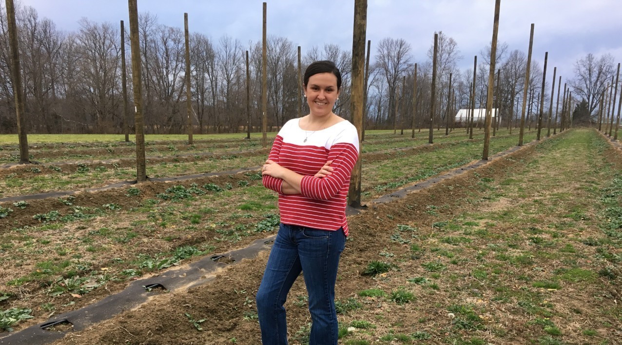 Hannah Scott standing in hop farm.