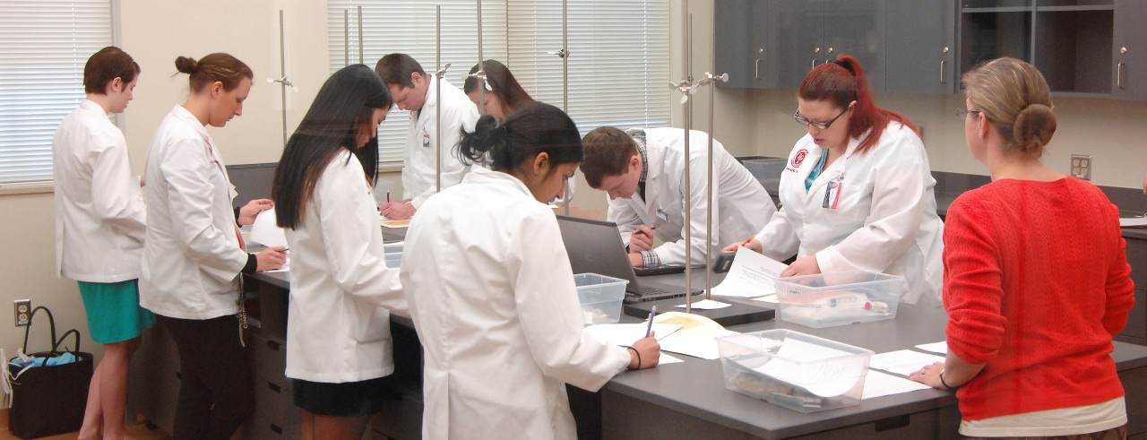 Pharmacy students in clinical skills lab at the James L. Winkle College of Pharmacy