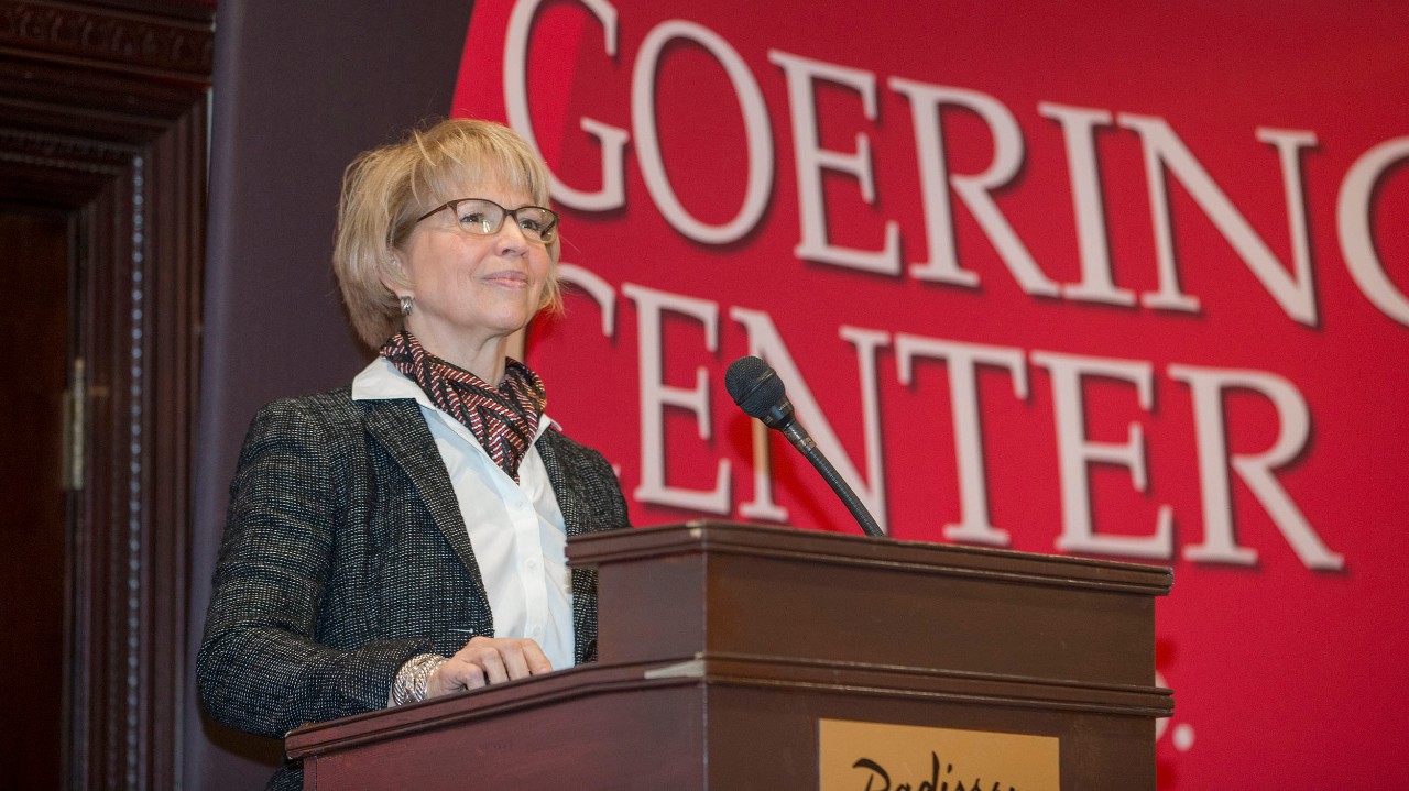Carol Butler, Goering Center President, welcoming attendees to a Goering Center luncheon at the Radisson Hotel in January 2019.