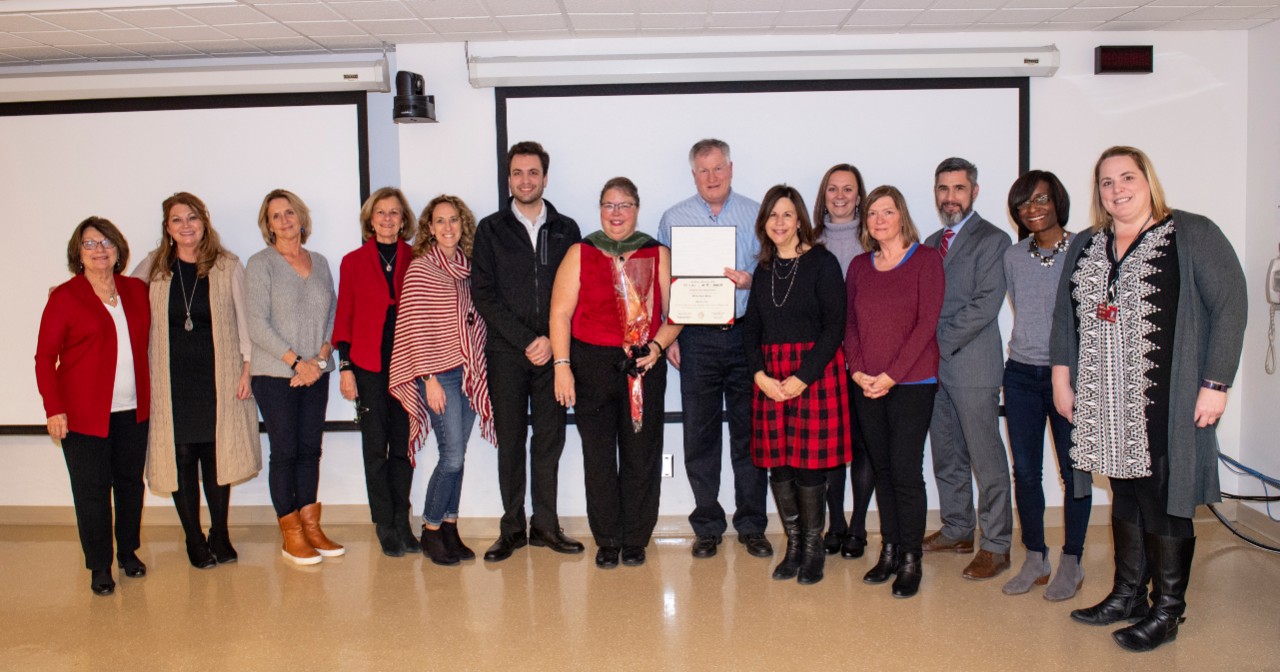 Faculty from the Department of Communication Sciences and Disorders with the family of Bill Waldeck as they are presented with his posthumous degreee