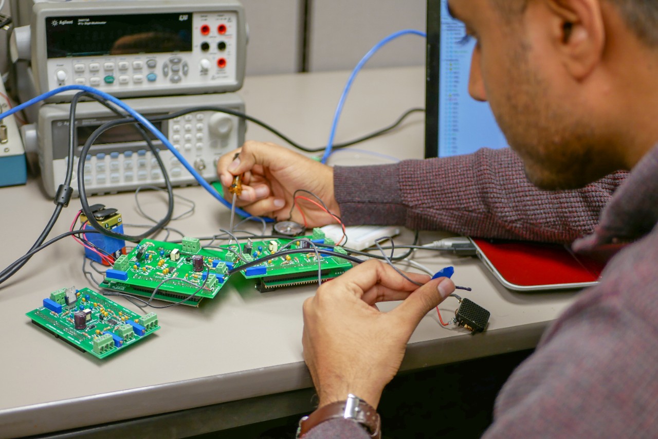 student works on hardware at desk