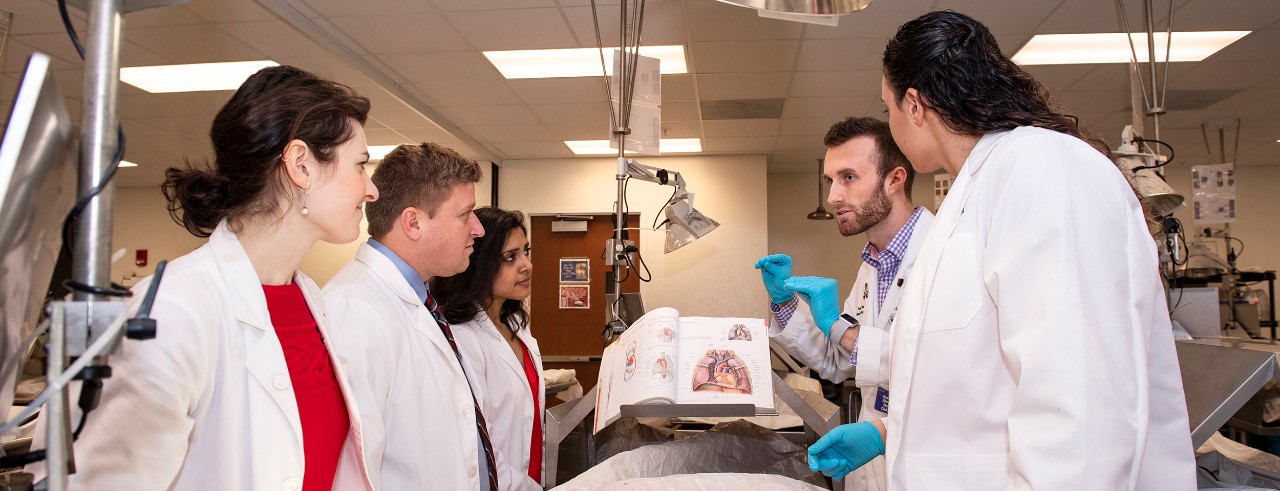 Five students on LCME subcommittee shown in College of Medicine gross anatomy lab.