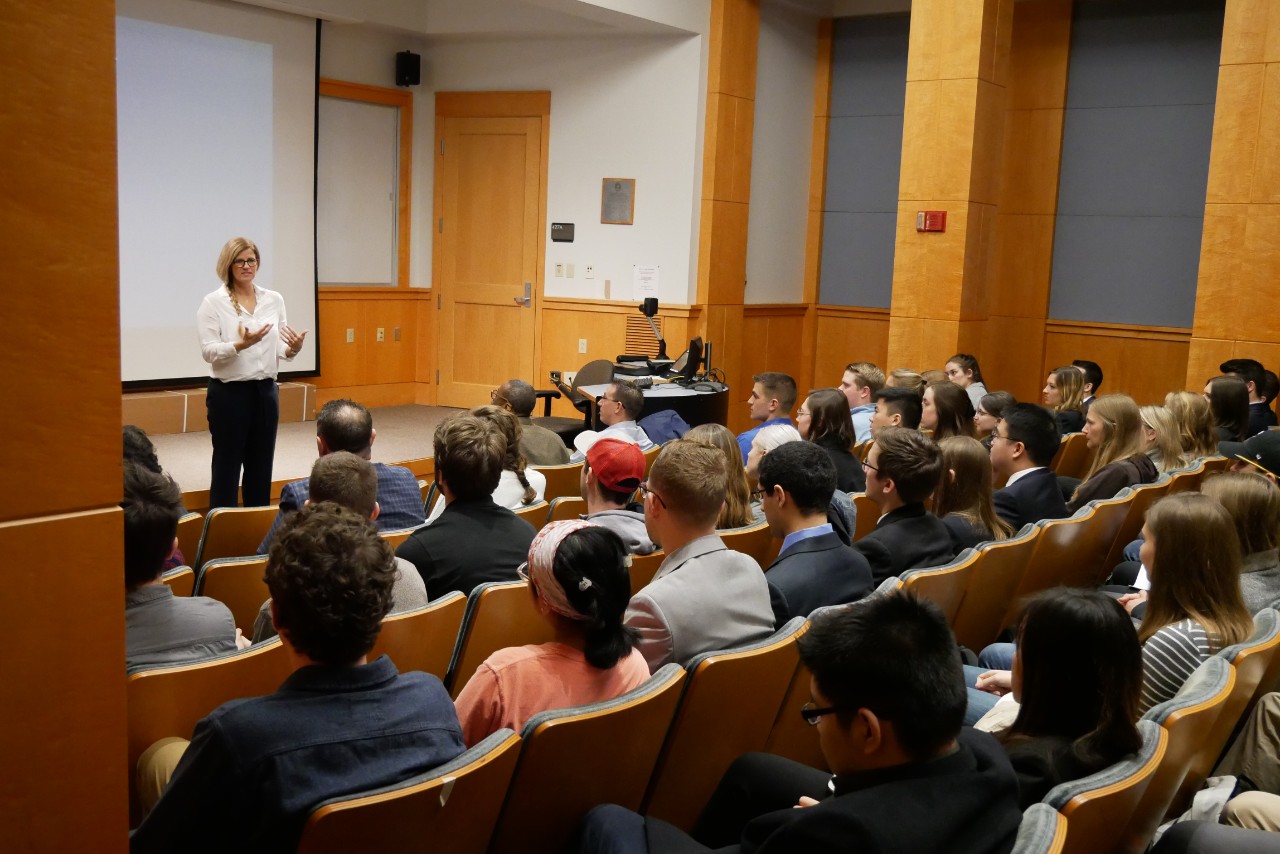 Mary Beth Privatera addresses a class in an auditorium.