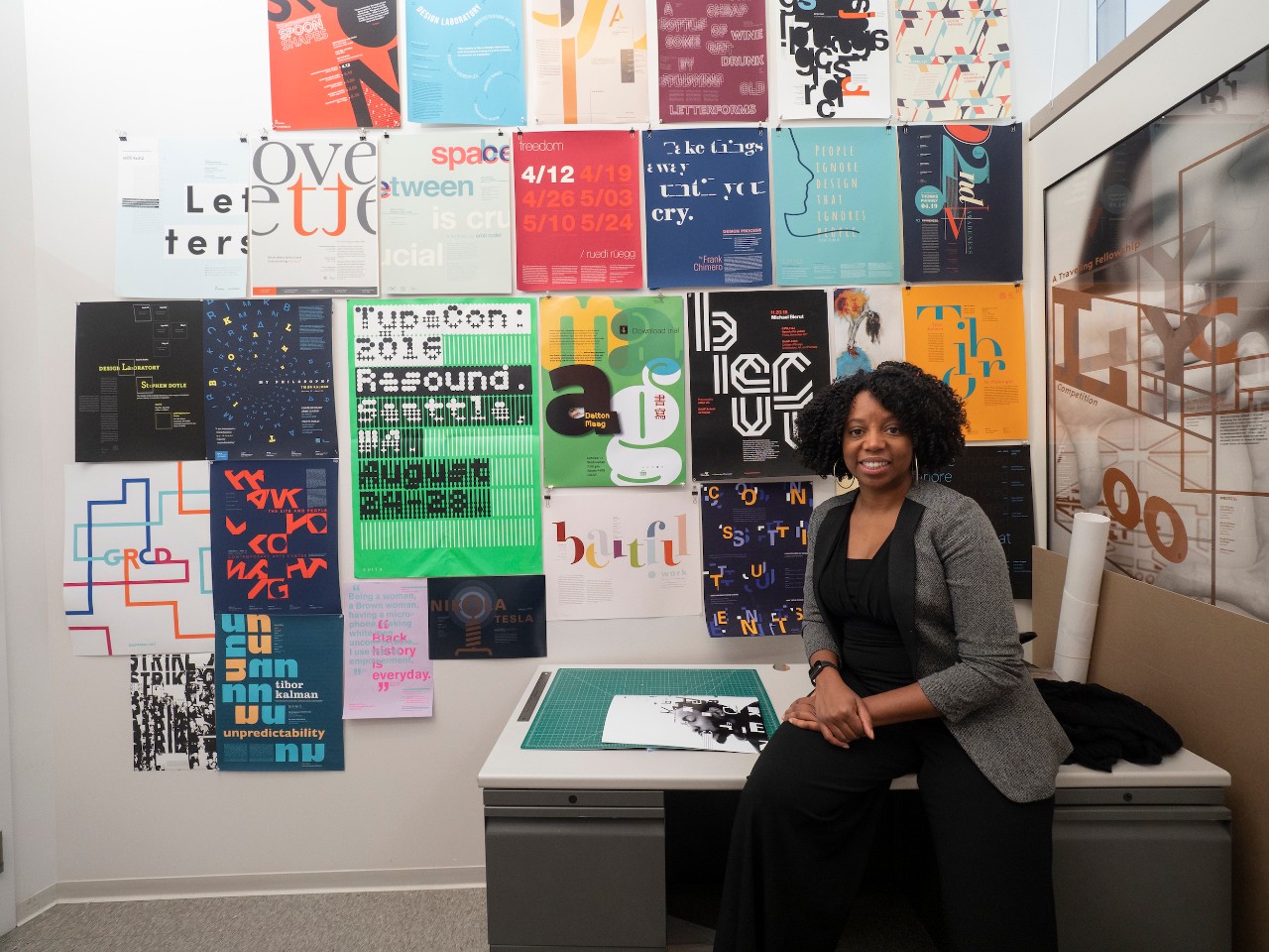 Reneé Seward poses in her office in front of posters