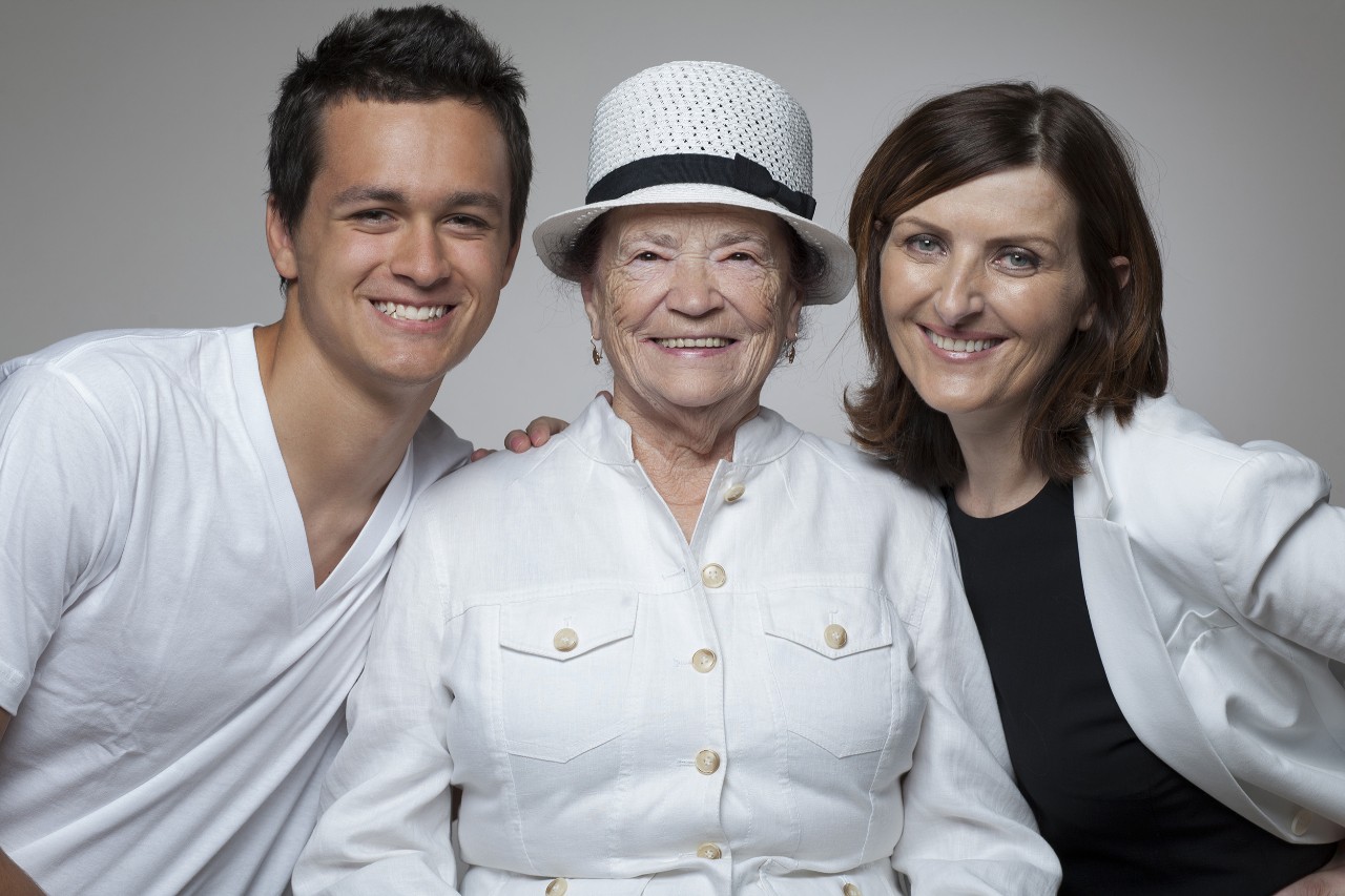 Happy 3 generations family in white clothes.