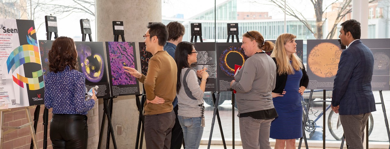 Participants at the Internal Medicine Research Symposium view images submitted as part of the image competition.