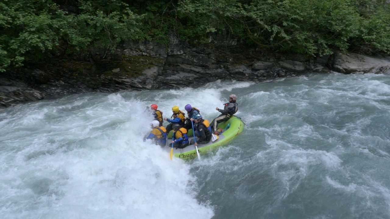 A team of adventure racers rafts down a river in Alaska.