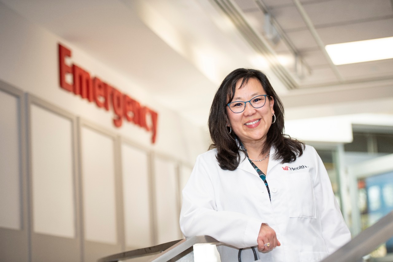 Dr. Liz Leenellett of the Department of Emergency Medicine standing by the entrance to the emergency department at UC Medical Center