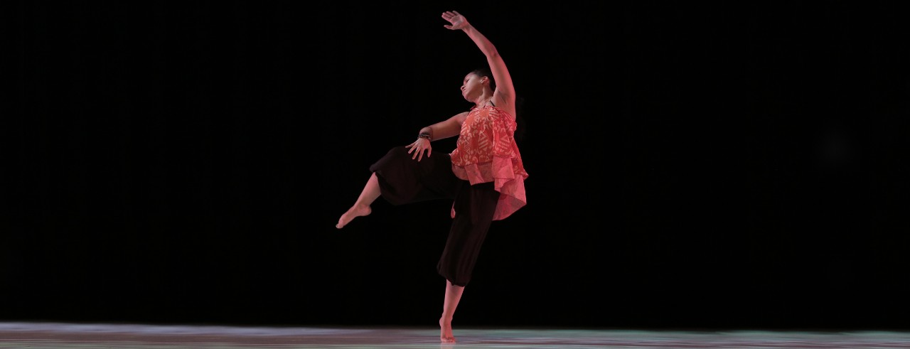 A photo of incoming CCM faculty member Shauna Steele dancing against a dark backdrop.