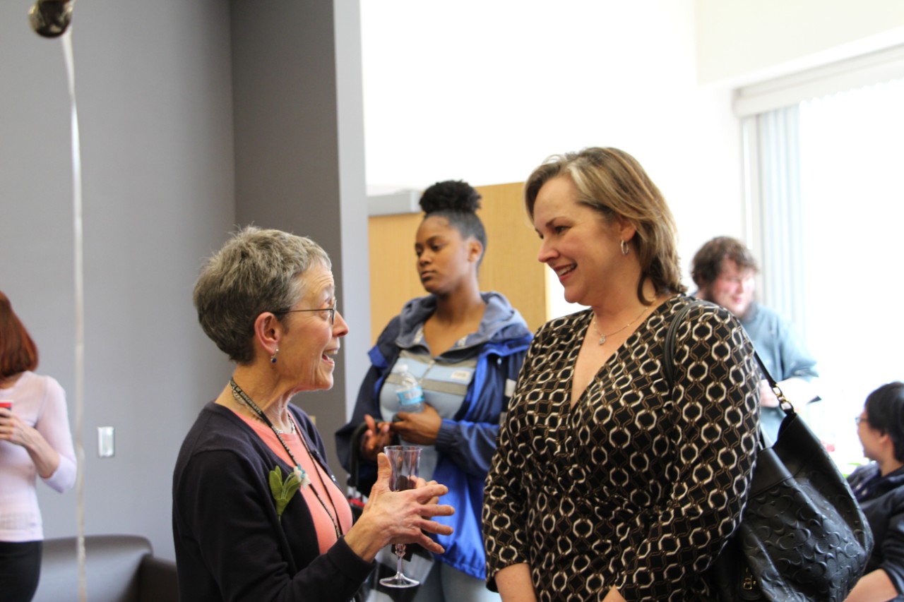 Picture of Joanna Mitro talking to friends at her retirement party on campus