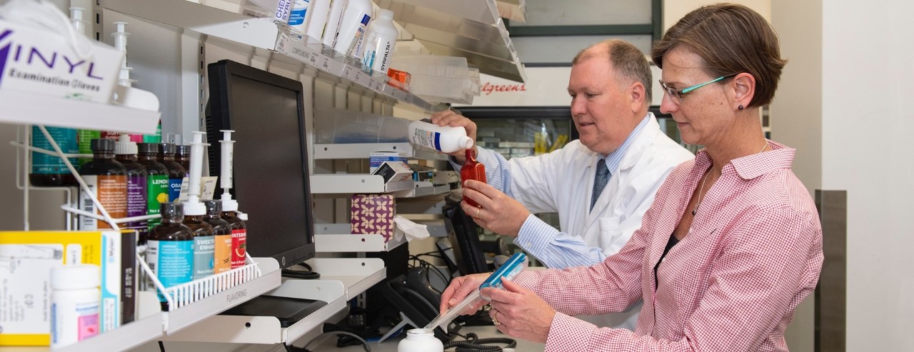 College of Pharmacy faculty member Bethanne Brown, PharmD, working side by side in a specialty Walgreens pharmacy to demonstrate collaboration between academia and industry